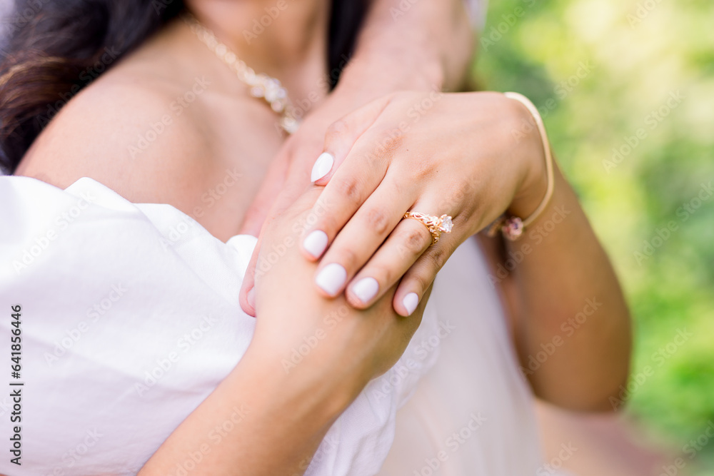 Hands and arms are wrapped around lover, husband, or fiance. Hands and arms are wrapped around lover, husband, or fiance.