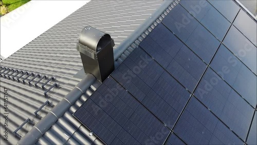 Solar panels on roof and electric car charging with solar power.