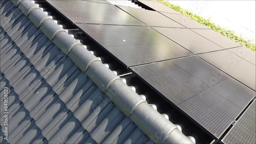 Drone movement over roof of a villa with solar panels