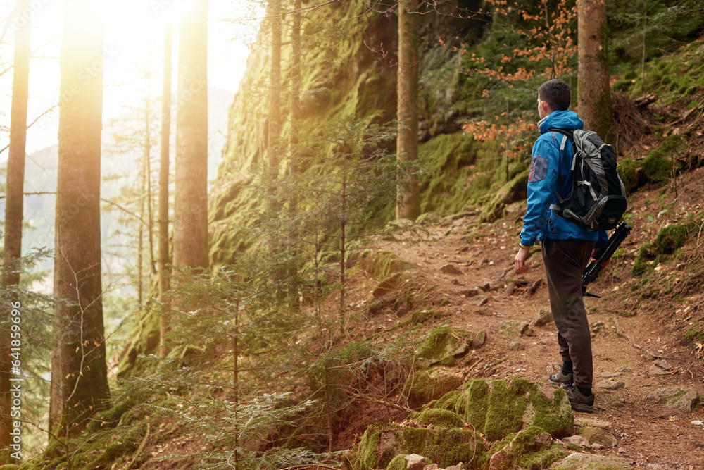 Naklejka premium Traveler Man with backpack mountaineering Travel Lifestyle concept mountains on background Summer trip vacations outdoor. Concept of travel and healthy, active lifestyle. Young guy with dreadlocks