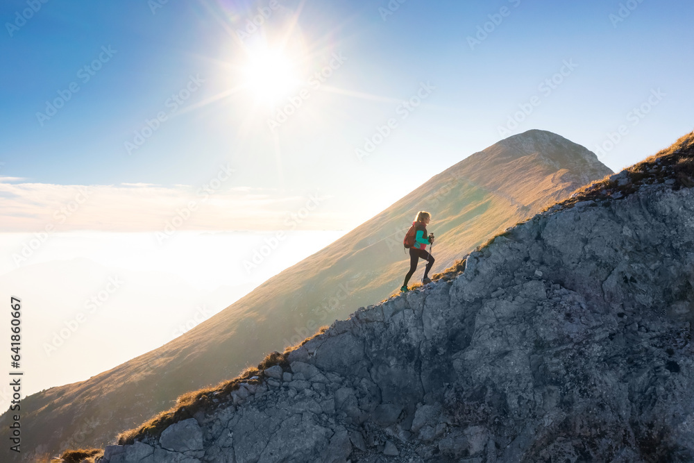 Ταπετσαρία Mountaineering on the mountain, a young woman hiking on the trail with trekking