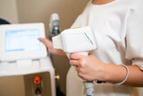 Laser for epilation in the hand of cosmetologist. 