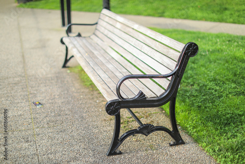 bench amidst bustling city - symbolizes solitude, reflection, urban respite, and shared moments of connection © Your Hand Please