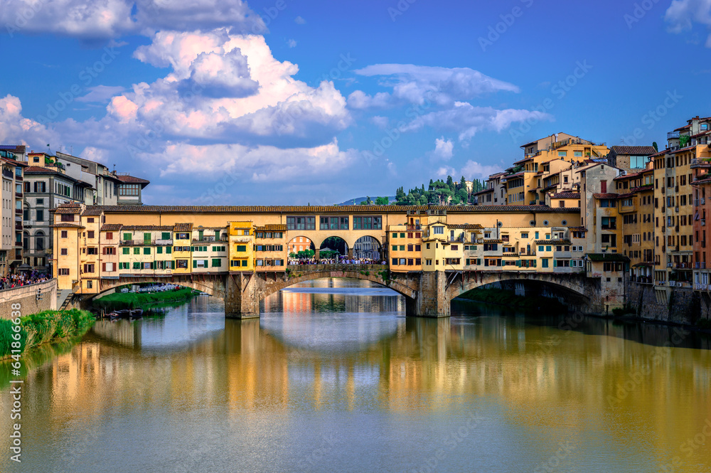 Ponte Vecchio (old Bridge) in Florence, Italy. This medieval stone bridge that spans river Arno, consists of three segmental arches and it has always hosted shops and merchants.