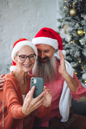 Canvas Print Happy loving senior couple having fun on New Year party near Christmas tree