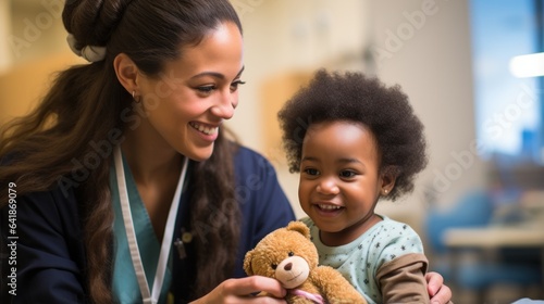 A doctor giving a teddy bear to a little boy.