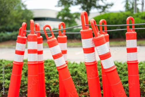 construction cone on the road signifies ongoing progress, caution, and temporary disruption in the journey ahead