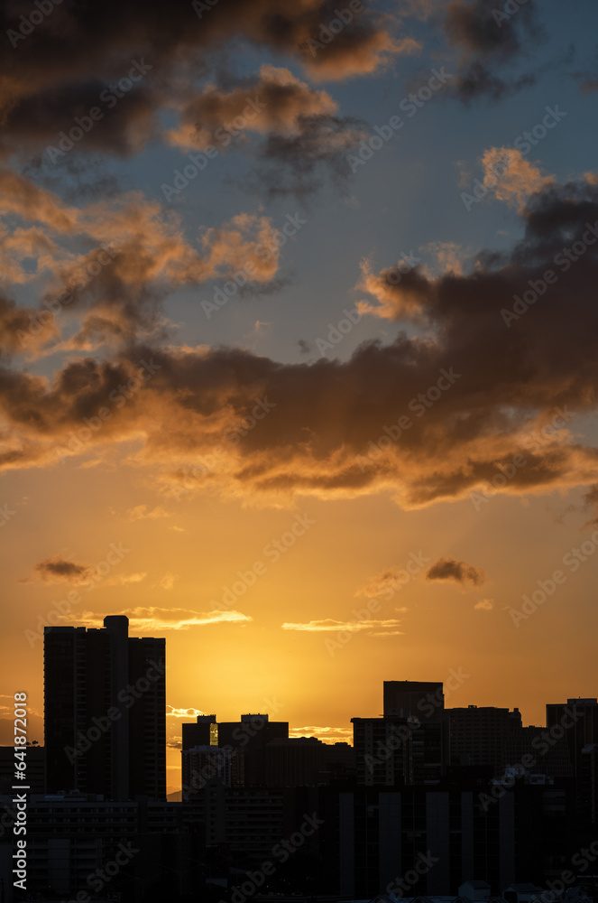 Sunset Over a Cityscape Silhouette.