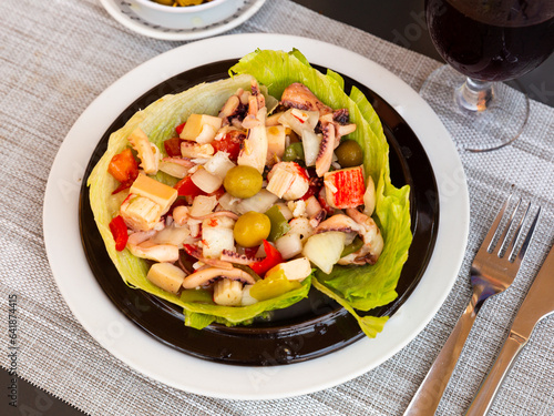 Popular salad of Spanish cuisine is Seafood Salpicon, made from chopped seafood and vegetables in a dressing or sauce photo