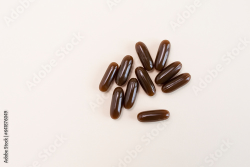 Isolated Flat lay Sunflower Lecithin Brown Softgel Pill, Capsule On White Beige Background. Top View Vitamin, Dietary Supplements. Lecithin Benefits, Copy Space, Design. Horizontal Plane
