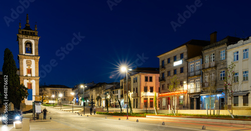 Evening spring view of illuminated Carvalho Araujo Avenue with belfry of cathedral in central part of Vila Real, Portugal. photo