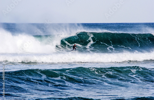 Surfer surfing the sea of Spain, with a beautiful tube. Presence of water splashes. Mundaka, Spain. no one in a wild place. Giant wave with a perfect tube only for professionals.