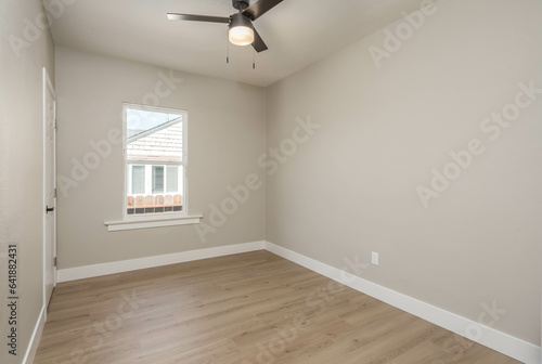 a empty residential room with a ceiling fan. Good for virtual staging and interior design photo
