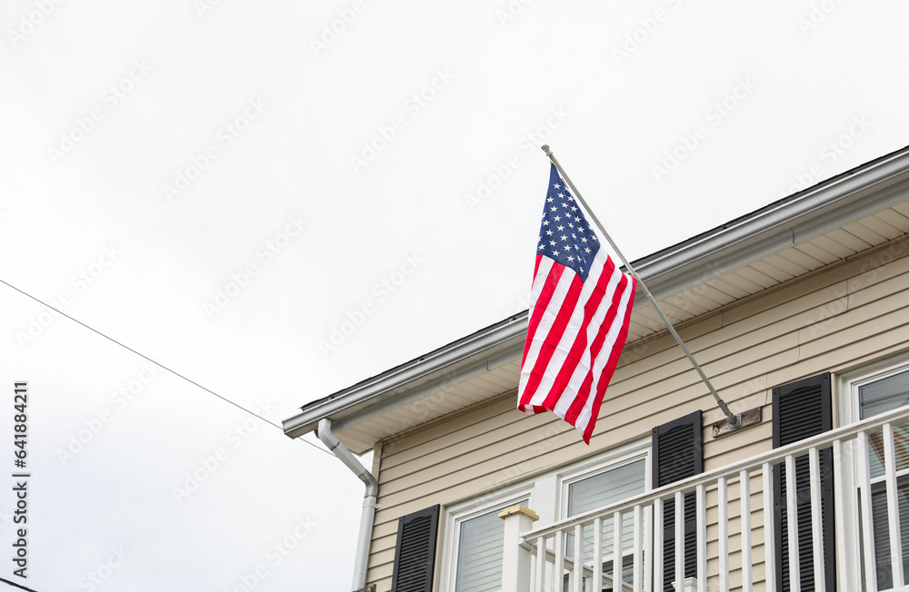 vibrant US flag waves against a clear sky, evoking American pride on a sunny day. Symbolizes patriotism, unity, and national celebration