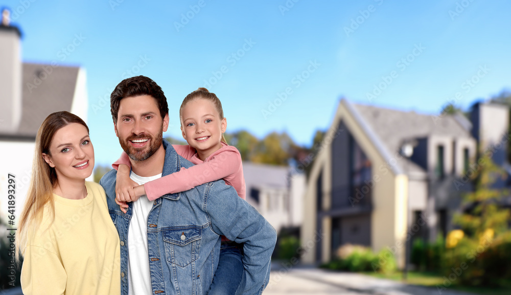 Naklejka premium Portrait of happy family with child on street
