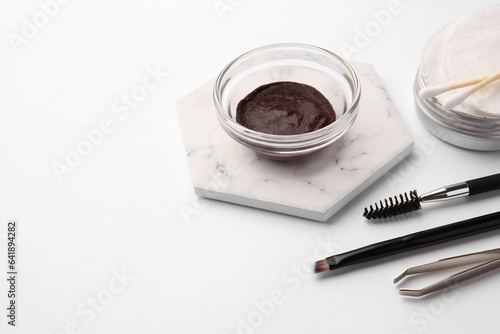 Eyebrow henna and professional tools on white background, space for text