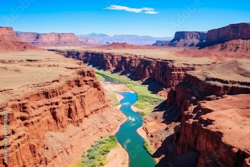 Captivating Southwest: Majestic Aerial Tapestry of Vibrant Rainbow Canyon, Towering Red Rocks, and Meandering Turquoise River