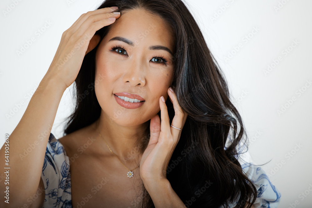 Fototapeta premium Asian young woman in summer dress against white background