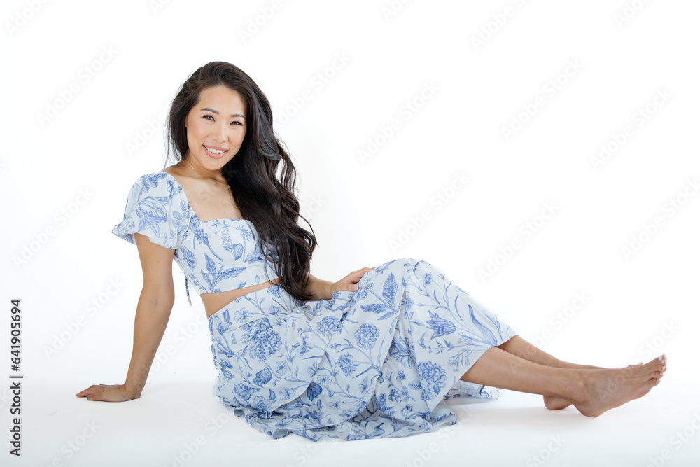 Asian young woman in summer dress against white background Asian young woman in summer dress against white background