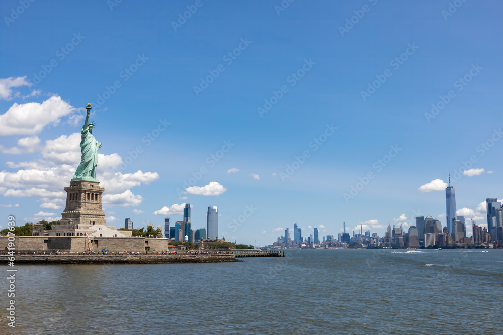 A view of the Statue of Liberty as seen from the ferry heading to Liberty Island on a bright sunny day.