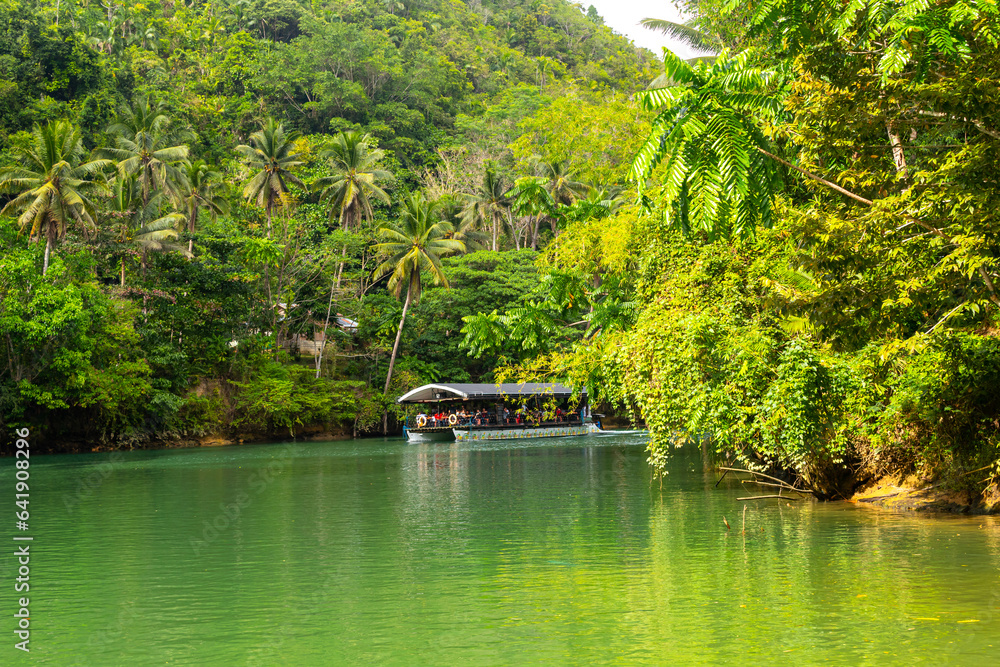 Bohol Loboc river cruise on Philippines. Palms, cloudy sky, hills Bohol Loboc river cruise on Philippines. Palms, cloudy sky, hills