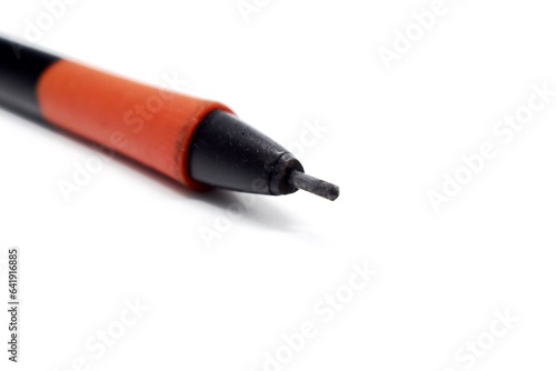 a mechanical pencil with red and black colors photographed on the isolated white background