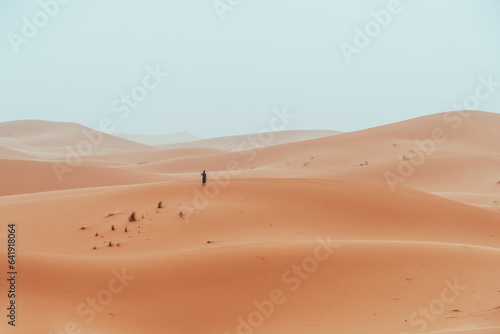 Incidental local berber man wandering through Sahara Desert Merzouga, Morocco
