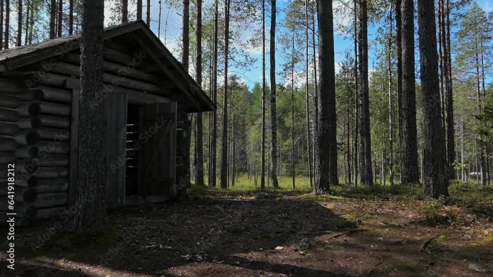 Wooden shed in forest, traditional storage house for firewood, Finland