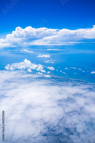 Background blue sky and white clouds seen from plane window. There is space for writing content. Natural sky  bright style.