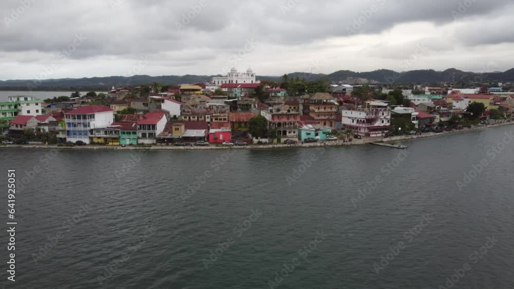 Aerial dolly: Low waterfront street, buildings in Flores, Guatemala Aerial dolly: Low waterfront street, buildings in Flores, Guatemala