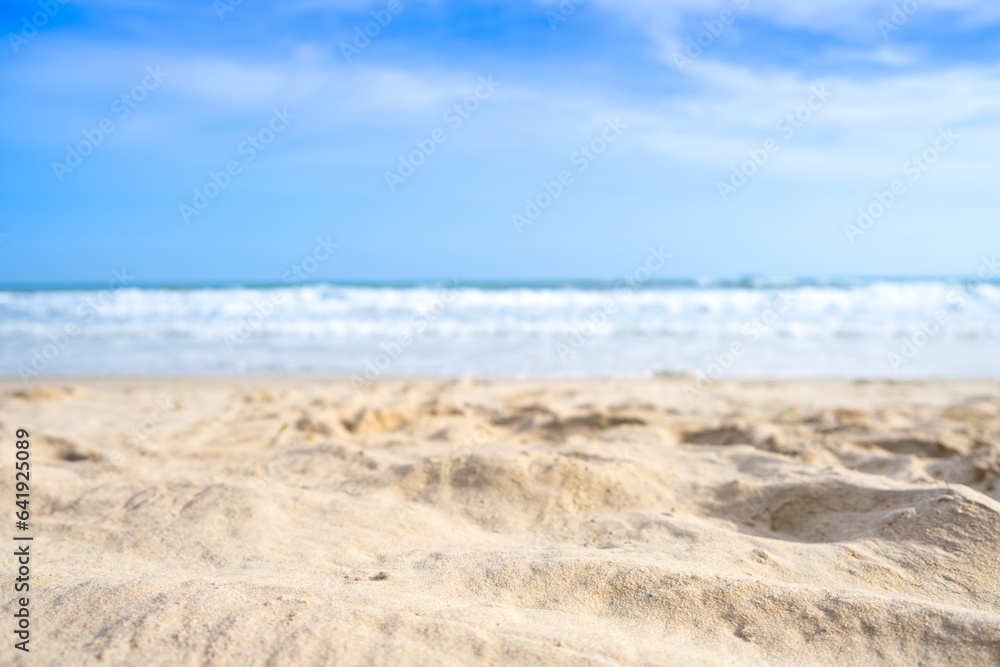 Beach sand background for summer vacation concept. Beach nature and summer seawater with sunlight light sandy beach Sparkling sea water contrast with the blue sky.