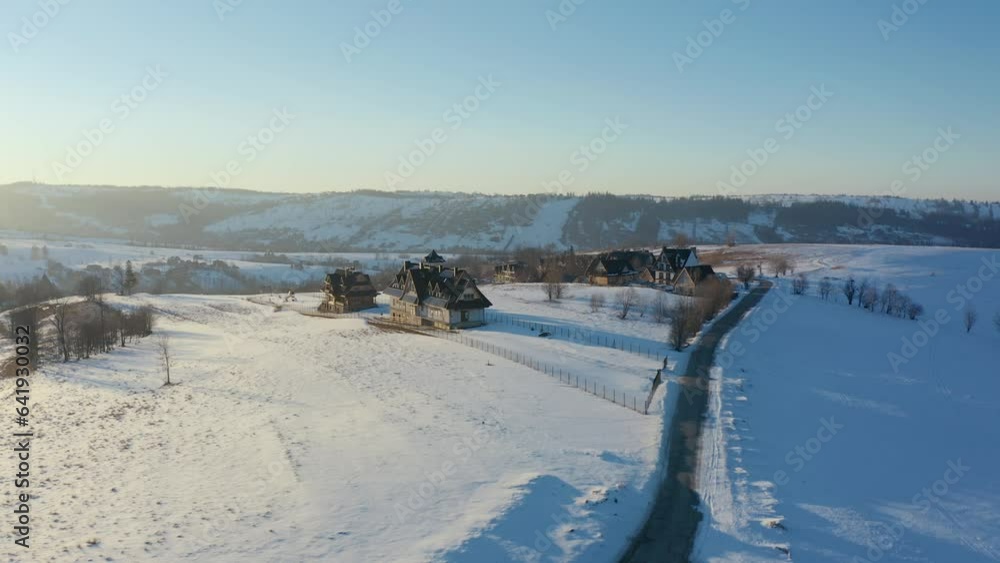 Polish Village Winterscape: Aerial Glimpse of Sunlit Road and Homes Polish Village Winterscape: Aerial Glimpse of Sunlit Road and Homes