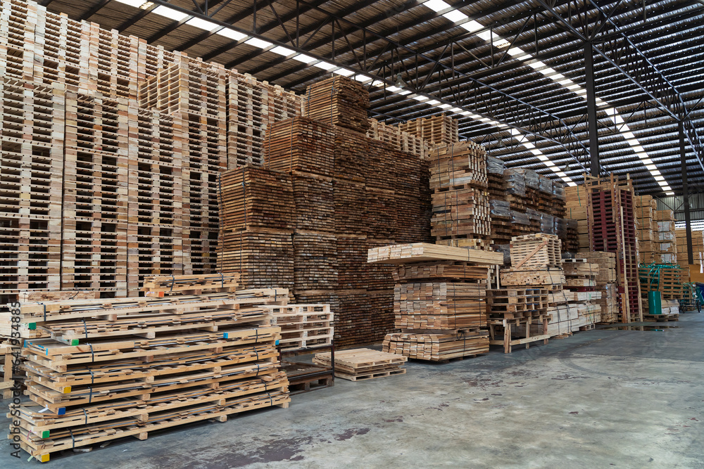 Pile of lumber in wooden warehouse storage. Pile of timber at warehouse storage. Pile of pallet in warehouse Pile of lumber in wooden warehouse storage. Pile of timber at warehouse storage. Pile of pallet in warehouse