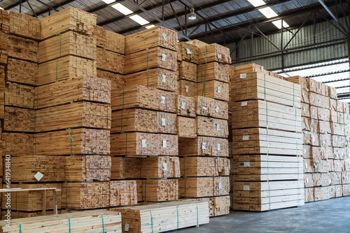 Pile of lumber in wooden warehouse storage. Pile of timber at warehouse storage. Pile of pallet in warehouse photo