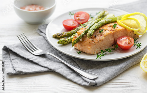 Baked Delicious salmon, green asparagus on plate