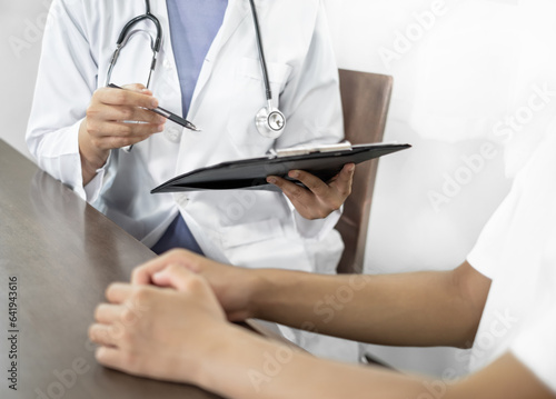 Female doctors who treat patients make an appointment to listen to the results after a physical examination and explain medical information and diagnose the disease. Medical concepts and good health