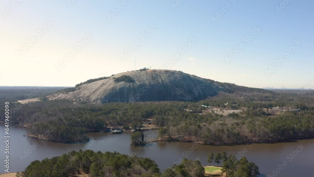 Aerial drone shot slowly circling Stone Mountain Park in Atlanta, Georgia on a sunny day with the city in the background. Aerial drone shot slowly circling Stone Mountain Park in Atlanta, Georgia on a sunny day with the city in the background.