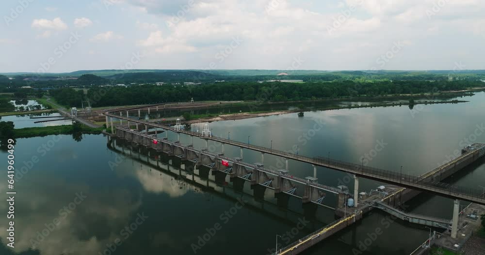 Big Dam Bridge With Mirror Reflections Over Arkansas River Near Cook's Landing Park In North Little Rock, Arkansas, USA. Aerial Shot Big Dam Bridge With Mirror Reflections Over Arkansas River Near Cook's Landing Park In North Little Rock, Arkansas, USA. Aerial Shot