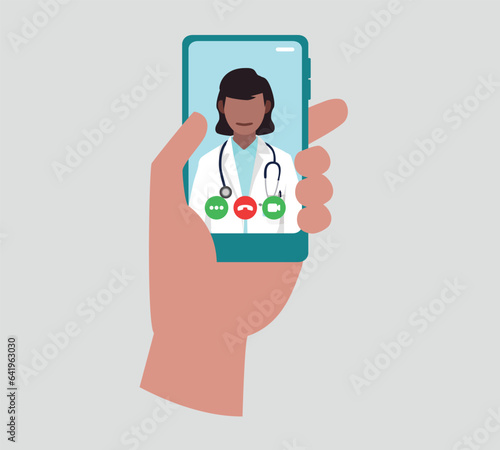 A doctor looks at us directly, she wears a stethoscope around her neck on a smartphone screen