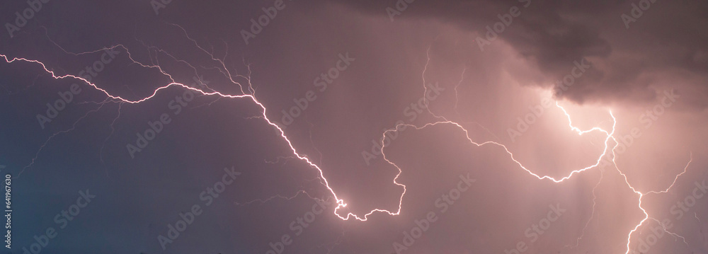 beautiful lightning during a thunderstorm at night in a forest that caused a fire, against a dark sky with rain beautiful lightning during a thunderstorm at night in a forest that caused a fire, against a dark sky with rain