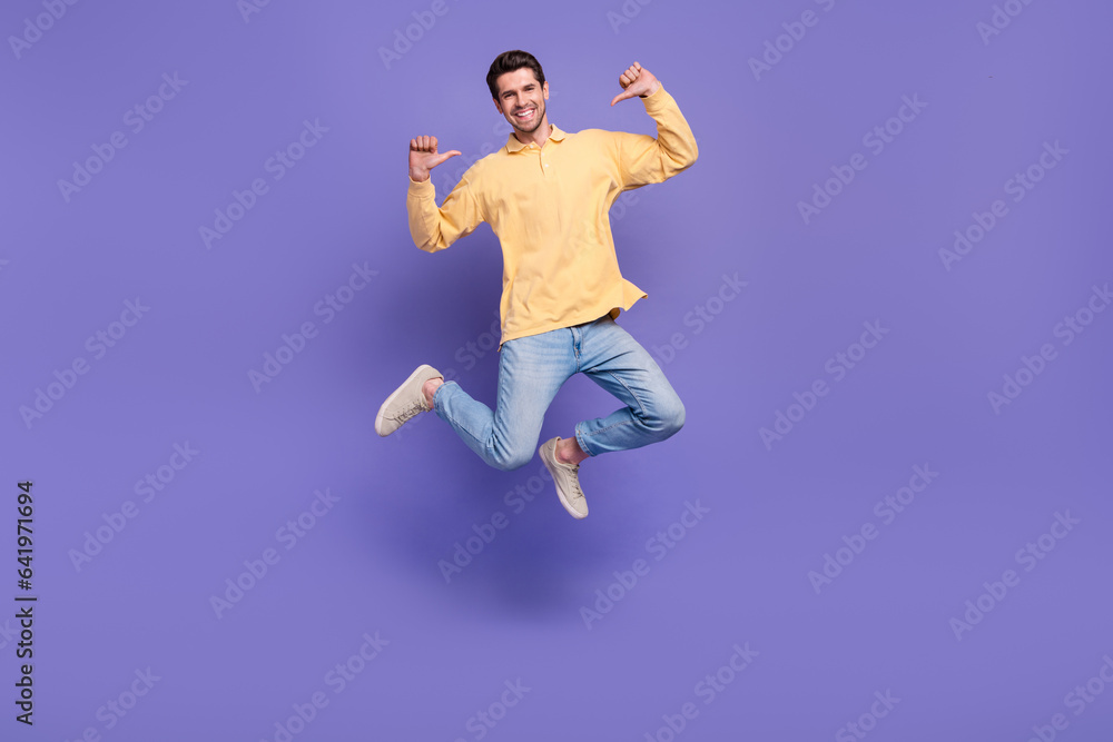 Full length body photo of jumping selfish guy directing fingers him personal branding jumper sportsman isolated on violet color background Full length body photo of jumping selfish guy directing fingers him personal branding jumper sportsman isolated on violet color background