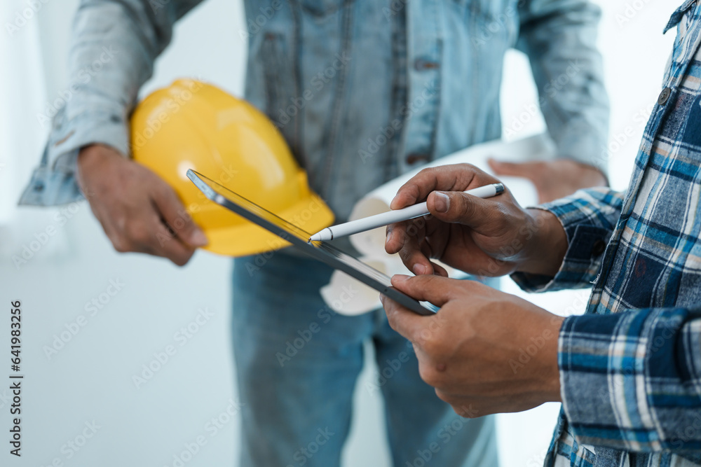 interracial group of architects and engineers on meeting on blueprint for project work in, construction workers on a construction site interracial group of architects and engineers on meeting on blueprint for project work in, construction workers on a construction site