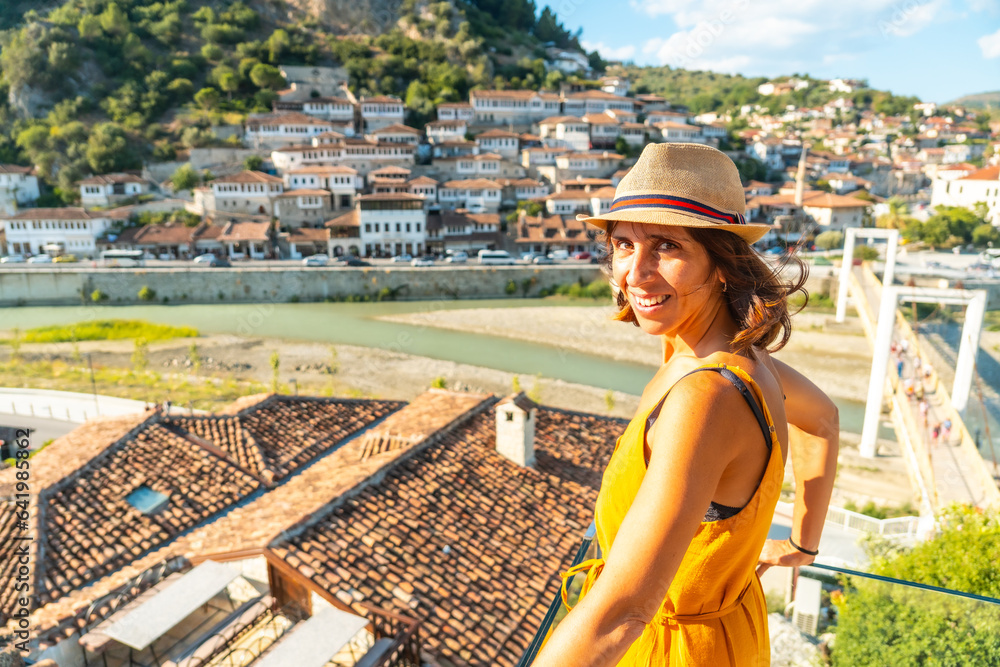 Portrait of a young woman looking at the historic city of Berat in Albania from a viewpoint, UNESCO