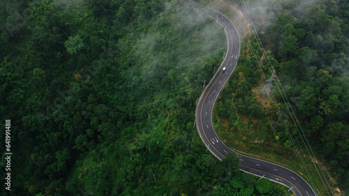 Aerial view road in the middle forest, Top view road going through green forest adventure, Ecosystem ecology healthy environment road trip travel net zero