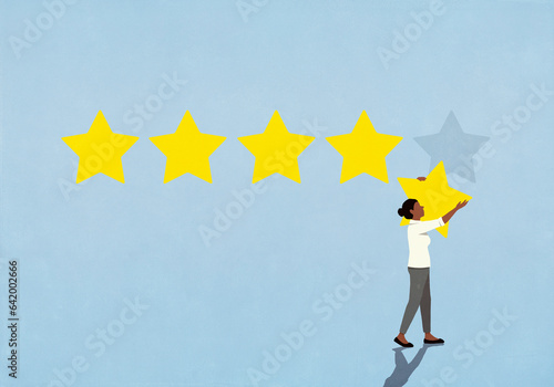 Woman removing rating star from blue background
