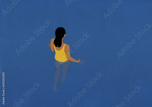 Woman walking into blue water
 photo