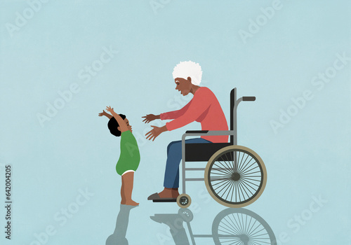 Senior grandmother in wheelchair reaching for baby grandson
 photo