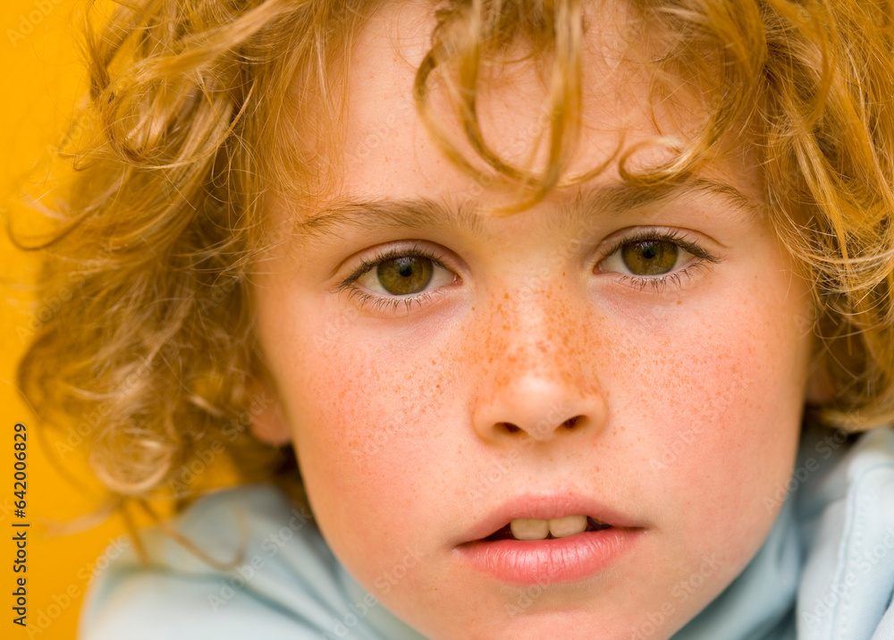 Close up of a young boy with curly hair
Close up of a young boy with curly hair