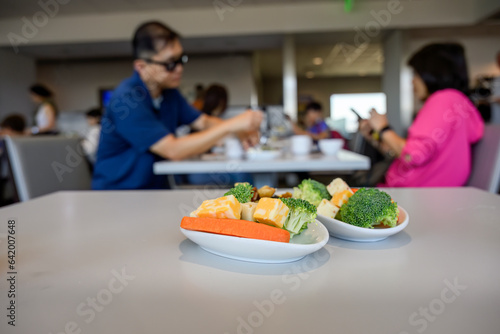 People enjoying healthy snacks at the airport lounge. Selective focus on bowls of snacks in the foreground.