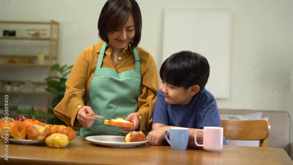 Mother serves them breakfast. Everyone is happy and smiling, enjoy spending time with their children. Mother serves them breakfast. Everyone is happy and smiling, enjoy spending time with their children.